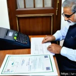 Home 18 상담심리사 자격증 갱신 절차 - A professional Pakistani office setting where a middle-aged man in formal attire is carefully organi...